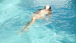 Beautiful Redhead's Playful Charm by the Poolside