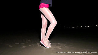 Anna in white shiny pantyhose on the night beach