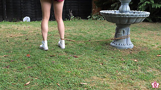 Half-stripped, Bell-jingling Slave Mila Drooling Through Tongue Clamp Is Made to Walk Outdoor Fountain Laps with Crotch Rope Saw