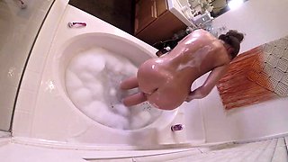 Stacked MILF masturbating in bathtub