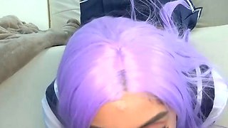 A youthfull adult girl with purple hair wears a sailor