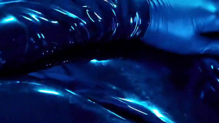 Tied up rubber girl in catsuit fucking herself