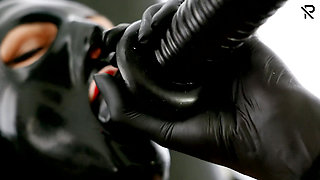 Rubberslut in the clinic masturbates with big dildo and deepthroats