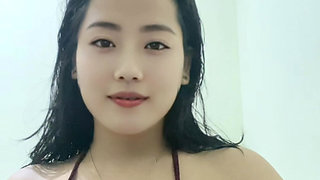 A young mother with big breasts, wearing a sexy outfit after a shower looking incredibly alluring.