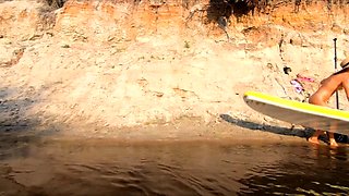 Tattooed Babe Strips and Swims on a SUP Board in the Forest